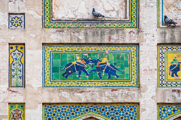 Detail of beautiful kashi-kari mosaic panels on historic Picture Wall built by mughal emperor Jahangir in Lahore fort, Punjab, Pakistan