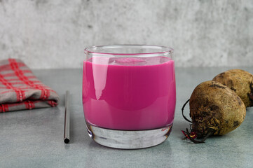 Serving beet smoothie in a glass cup.