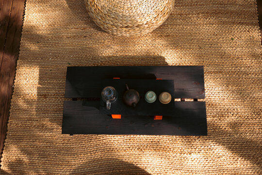 Prepared tea ceremony arrangement on a traditional chaban tea table with teapot and cups, capturing harmony, readiness, and the ritual atmosphere of traditional tea culture.