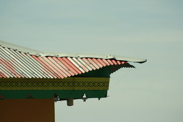 Traditional Asian temple and house roofs with ornate architectural details under an open sky, reflecting ancient cultural heritage and historic city landscapes
