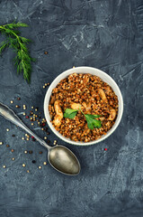 Buckwheat porridge cooked with chicken, top view, copy space.