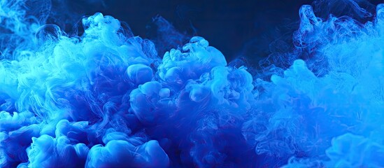 Abstract Blue Ink Cloud Forming Shape on Dark Background