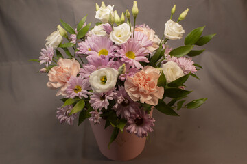 pastel floral bouquet with daisies and roses, florist arranging cheerful gift composition for celebration, soft textures, muted