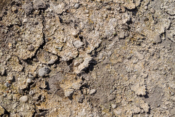 Cracked dry ground surface texture background with small gravel details