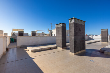 Spacious rooftop terrace with ventilation towers and barbecue area