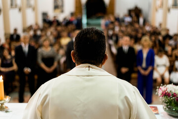 A priest giving a religious ceremony in a church full of worshippers © virginia
