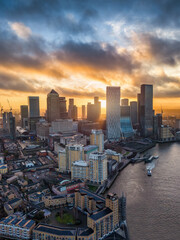 Panoramic aerial view of the Docklands and Canary Wharf district in London, England, during a colorful sunrise