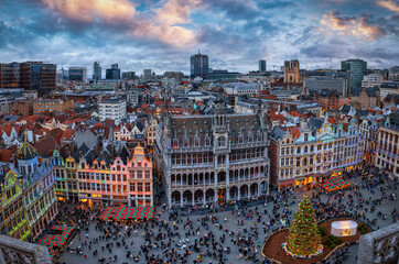 Panoramic view over the Grand Place in Brussels, Belgium, decorated for Christmas time with the illuminated skyline in the background during winter dusk