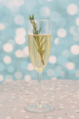 Champagne with decoration for Valentine's Day, wedding, anniversary, party, carnival or so on. Shiny decorations, hearts, bokeh, blue, romantic background.