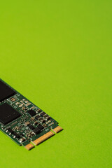 Close up of M.2 SSD circuit and connector on green background with copy space. High quality photo