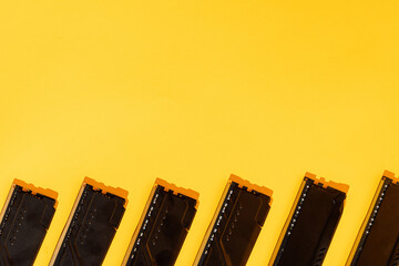 Black RAM modules along bottom edge on yellow background, copy space. High quality photo