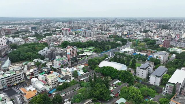  Aerial panoramic view of Chiayi City urban sprawl in Taiwan. High density residential cityscape with mix of modern buildings and traditional rooftops