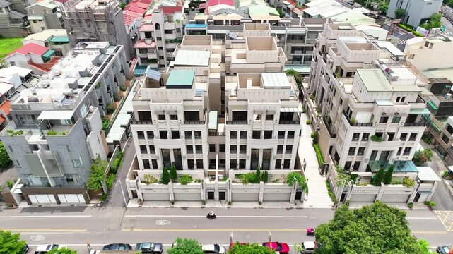 Aerial tracking shot of elegant Neoclassical stone villas in Chiayi, Taiwan, featuring symmetrical granite facades, Art Deco geometric details, and luxury multi-story architecture, 4K Drone.