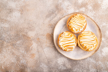 French lemon tart with meringue on brown concrete, top view, flat lay, copy space