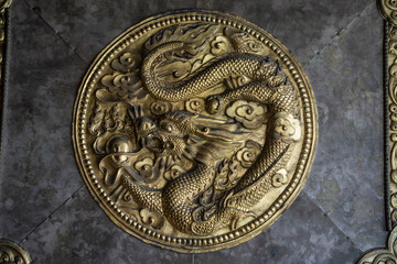 relief of a copper dragon on the temple door, Tagong temple, Tagong Grassland, Garzê Tibetan Autonomous Prefecture, Sichuan,  China