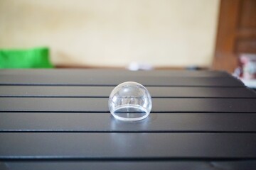 Unassembled LED bulb covers and bases on a table with blurred background, representing innovation...