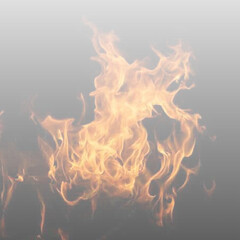 Fototapeta premium Flames dance across a dark surface with vibrant colors. Smoke spirals rise above glowing embers. Excellent for fire, energy, or abstract artwork. PNG