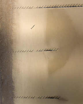 Aerial view of shadows cast by groynes patterning the sandy expanses of Camber Sands, where the wet sand reflects light, Camber Sands, England, United Kingdom.