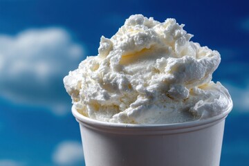 White Ice Cream Scoop in Cup Against Sky