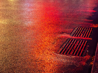 Wet asphalt street reflecting city night lights © Artem