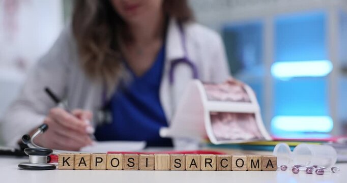 Text Kaposi Sarcoma on wooden blocks against doctor holding patient scan images in hospital. Cancer form masses on skin in lymph nodes in mouth