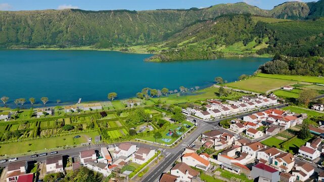 Drone view of Sete Cidades settlement near blue Lagoa Azul lake inside volcanic caldera, Sao Miguel Island
