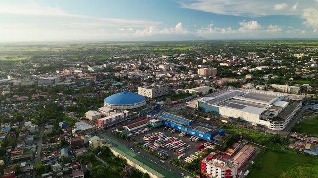 Picturesque aerial view of bustling Naga City business district and residential area with Jesse Robredo Coliseum and bus terminal, Philippines