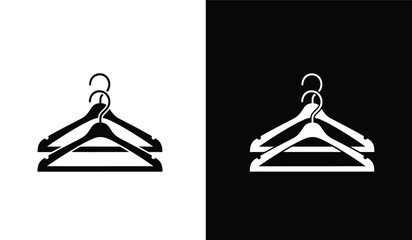 A striking visual contrast depicts two identical clothing hangers one in stark white against black and the other in black against white showcasing duality © ARSM D