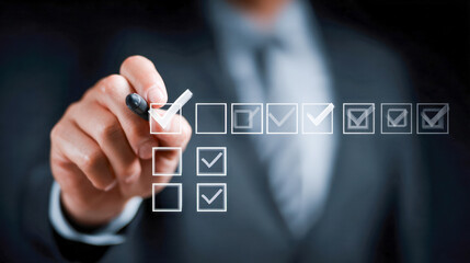 Businessman in suit marking multiple checkboxes on transparent virtual screen representing task completion and productivity in professional environment