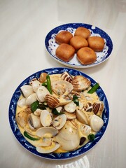 Seafood gravvy with pastry bun in blue plate