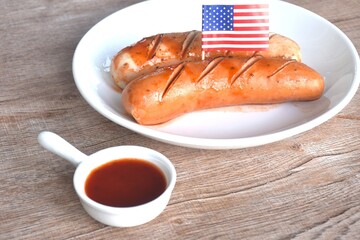 grilled smoked German and American pork sausage arranging on plate dipping ketchup sauce