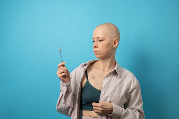 Cancer patient holding syringe with calm determination, symbol of health care, therapy, and modern oncology medicine.