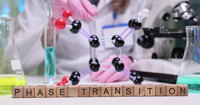 Woman laboratory worker observes changes in color and texture of liquid reagent. Phrase Phase Transition emphasizes focus of current experiment