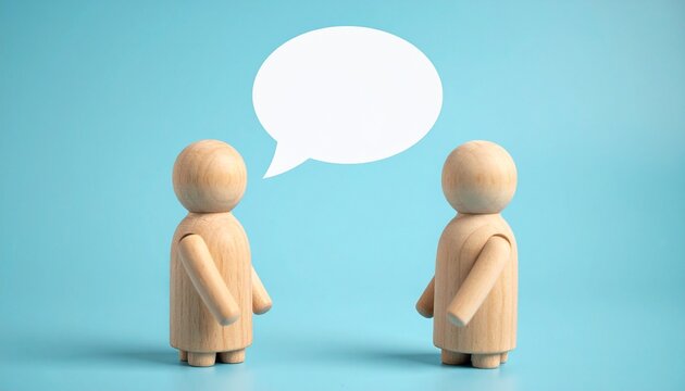 Two wooden figurines facing each other with speech bubble on light blue background.