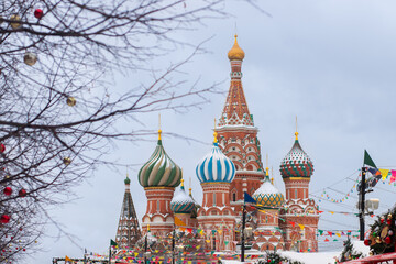Christmas fair in winter on Red Square in Moscow, people enjoying holiday lights and festive atmosphere, outdoor stalls with traditional decor and gifts.