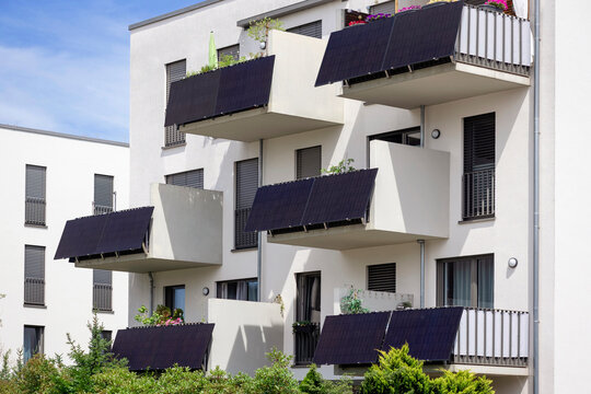 Solar Panels Balcony of Modern Residential Apartment Building in Eco City. Photovoltaic Panel Energy on all Balconies of Modern Building. Energy Efficiency of  Urban Life in Green City.