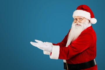 Santa Claus holding hands for present