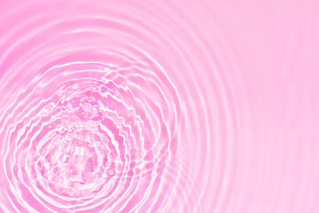 Pink water bubbles on the surface ripples. Defocus blurred transparent pink colored clear calm...