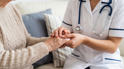 Compassionate healthcare professional holding elderly patient hands showing empathy and care in soft natural light setting