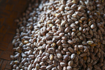 Obraz premium Close up view of an abundant pile of raw tiger striped peanuts. natural texture and pattern of legume shows wholesome and fresh ingredient for healthy eating