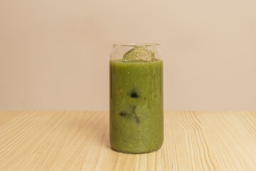 A detox drink with ice in a clear glass