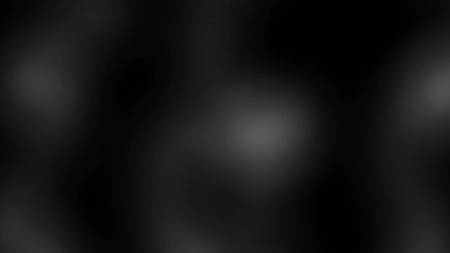 Abstract blurry grayscale light animation with soft motion on dark background
