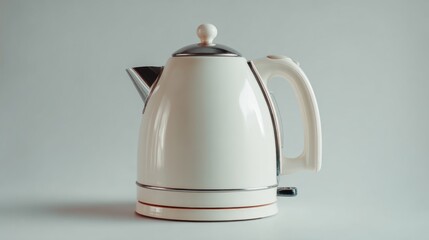 A clean white electric kettle sits on a white surface with a light gray background.