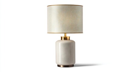 A modern cream and gold table lamp sits on a white background, casting a soft shadow.