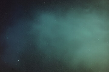 Fototapeta premium Abstract vintage film texture background with moody teal fog and subtle grain, dark vignette edges and tiny dust specks, dreamy atmospheric backdrop with empty copy space for banner, poster, cinematic