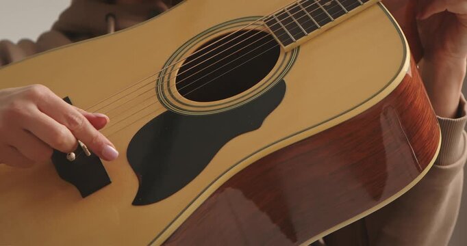 Close up of Hand Playing Acoustic Guitar Strings