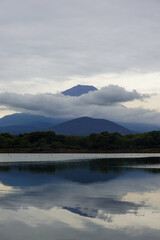 Mount Fuji reflected in still lake water at dawn
