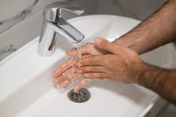 Close up picture of a man washing his hands