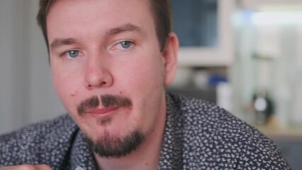 closeup white man tasting cake with fork, slow savoring expression in bright kitchen, food blogger sampling homemade dessert, subtle smile, candid lifestyle footage for cooking review and social