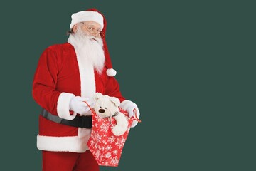 Classic Santa man holding a bag with gifts